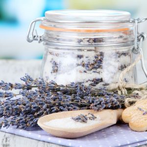 fresh lavender and lavender infused sugar on a napkin with wooden spoon